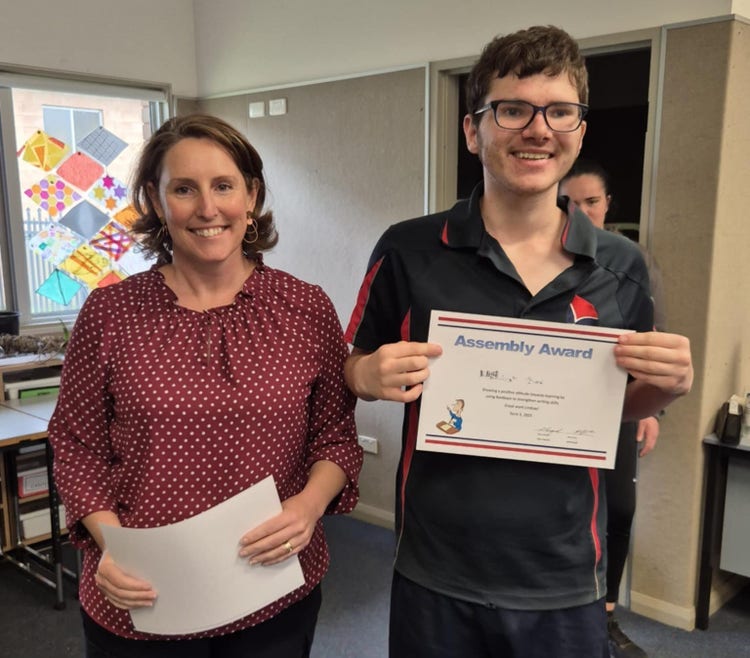 Teacher presenting student with term award