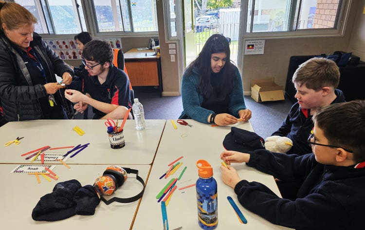 Photo of classroom with students and teachers engaged in science experiments
